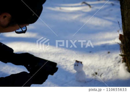 雪だるまの写真を撮る男性 110655633