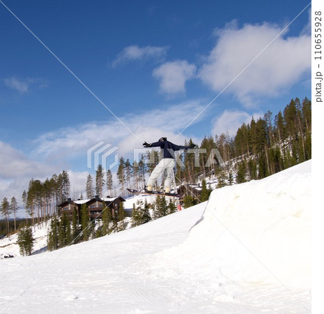 Young man jumping with a snowboard 110655928