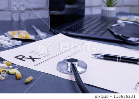Prescription with laptop and pills on table 110656231