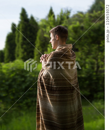 Praying man in the garden 110658072