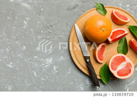 fresh Fruit grapefruit slices on colored background. Top view. Copy Space. creative summer concept. Half of citrus in minimal flat lay with copy space fresh Fruit grapefruit slices on colored background. Top view. Copy Space. creative summer concept. Half of citrus in minimal flat lay with copy space 110659720