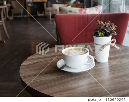white coffee cup on wooden table or counter in coffee shop 110660265