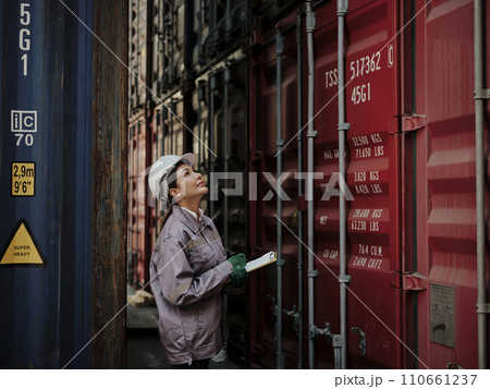 Portrait of a female worker holding clipboard 110661237