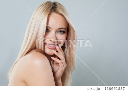 Happy smiling joyfully female model with fair hair looking at camera, being happy.  110661887