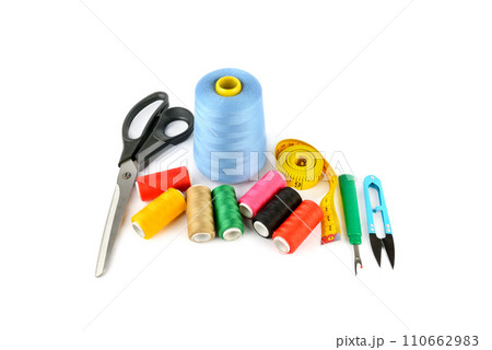 Sewing supplies (thread, scissors and measuring tape) isolated on a white. 110662983