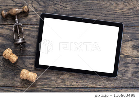 Mockup with tablet and vintage corkscrew on oak wooden table 110663499