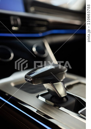 Selector automatic transmission with leather in the interior of a modern expensive car. The background is blurred. Black and brown leather car. Selector automatic transmission with leather in the interior of a modern expensive car. The background is blurred. Black and brown leather car. 110663788