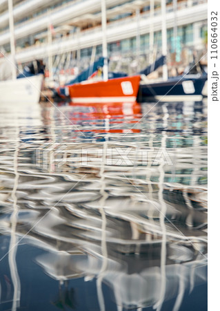 Monaco, Monte-Carlo, reflection of a lot of sailing boats are moored in new Yacht Club at the world championship of J70 class, port Hercules, sunny weather Monaco, Monte-Carlo, reflection of a lot of sailing boats are moored in new Yacht Club at the world championship of J70 class, port Hercules, sunny weather 110664032