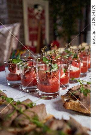 light snacks for the holiday, catering. Various light snacks. Catering plate. Assortment of sandwiches on the buffet table. meat, fish, vegetable canapes. 110664270