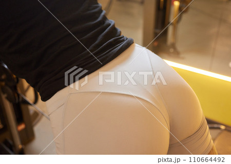 Close-up of a woman doing deadlift exercise alone at the gym. Close-up of a woman doing deadlift exercise alone at the gym. 110664492