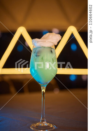 Summer cocktail with fruit and ice. Drink on white table over pink wall in sunlight with palm leaf shadow. Summer, tropical, fresh cocktail concept. Summer cocktail with fruit and ice. Drink on white table over pink wall in sunlight with palm leaf shadow. Summer, tropical, fresh cocktail concept. 110664602