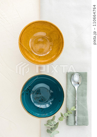 Set of two empty soup bowls with cutlery on table. View from above Set of two empty soup bowls with cutlery on table. View from above 110664764