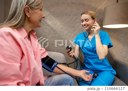 Nurse or doctor checking blood pressure to senior woman. Nurse or doctor checking blood pressure to senior woman. 110666127
