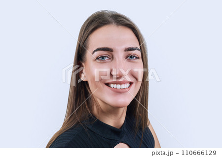 Portrait of smiling beautiful woman looking at camera on white background 110666129