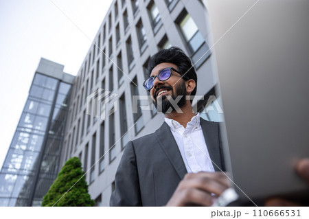 Young businessman in eyeglasses feeling positive and joyful 110666531