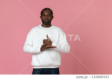 Deaf mute black man wearing white sweatshirt gesturing sign language 110666581
