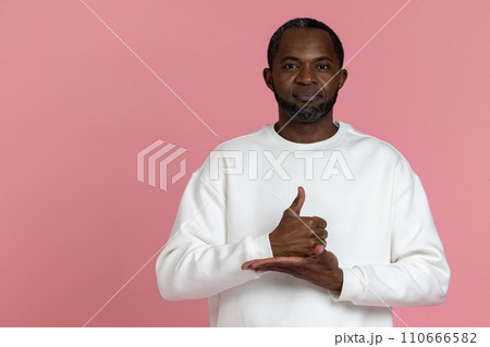 Deaf mute black man wearing white sweatshirt gesturing sign language 110666582