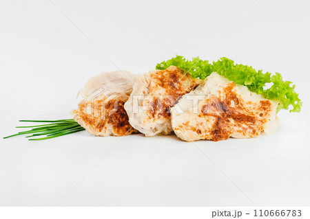 Chicken fillets fried until half cooked, semi-finished product with fresh herbs on a white background. Fast food. Quick cooking at home. Copy space.Fast cooking.Fast homemade food. 110666783