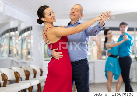 Pair dances - men and women in festive attire dance tango Pair dances - men and women in festive attire dance tango 110670100