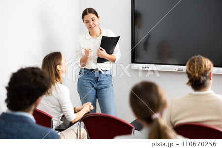 Young female teacher giving lecture to group of student Young female teacher giving lecture to group of student 110670256