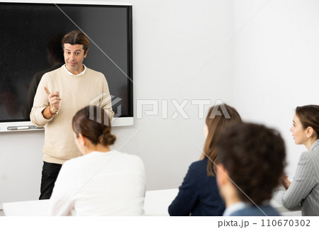 Experienced male teacher giving lecture to group of student Experienced male teacher giving lecture to group of student 110670302
