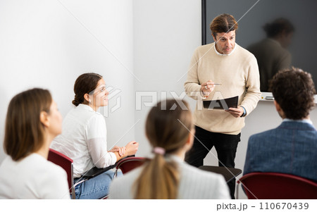 Experienced male teacher giving lecture to group of student Experienced male teacher giving lecture to group of student 110670439