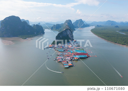 Aerial view of Koh Panyee, The Floating village urban city town houses, lake sea or river. Nature landscape fisheries and fishing tools at Pak Pha, Phang Nga, Thailand. Aquaculture farming Aerial view of Koh Panyee, The Floating village urban city town houses, lake sea or river. Nature landscape fisheries and fishing tools at Pak Pha, Phang Nga, Thailand. Aquaculture farming 110671080