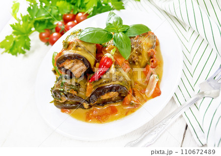 Rolls of eggplant with mincemeat in plate on white board 110672489