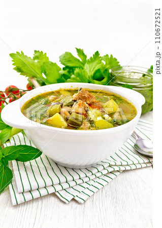 Soup with pisto sauce in bowl on light wooden board Soup with pisto sauce in bowl on light wooden board 110672521