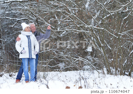 Happy senior couple at snowy winter park. Happy senior couple at snowy winter park. 110674047