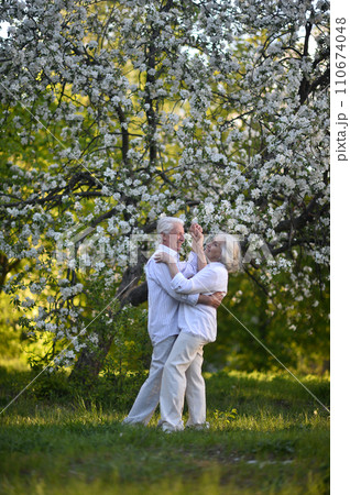 Mature couple on a walk in the park in summer Mature couple on a walk in the park in summer 110674048