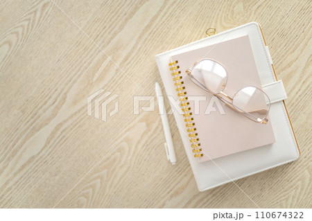 Business planning time management job organization concept stack of notepad on wooden table top view Business planning time management job organization concept stack of notepad on wooden table top view 110674322
