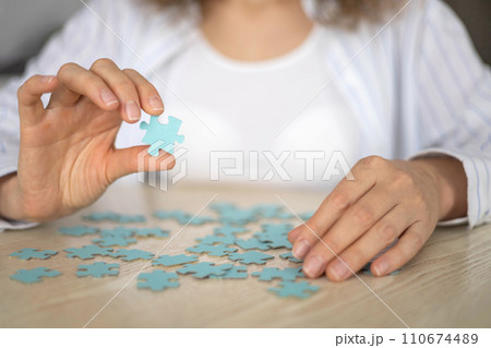 Business woman hands assembling puzzle details concept of finding solution solving problem top view 110674489