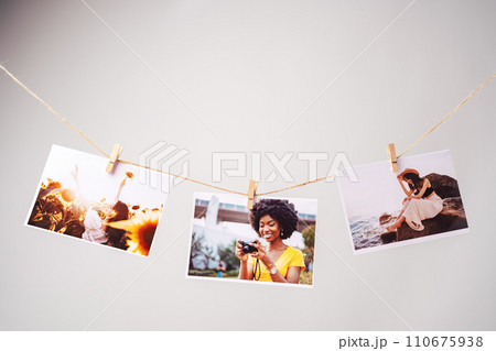 Printed colorful photos of women portraits against gray background 110675938