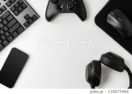 Top view of gamer table with computer keyboard, joystick and headphones Top view of gamer table with computer keyboard, joystick and headphones 110675968