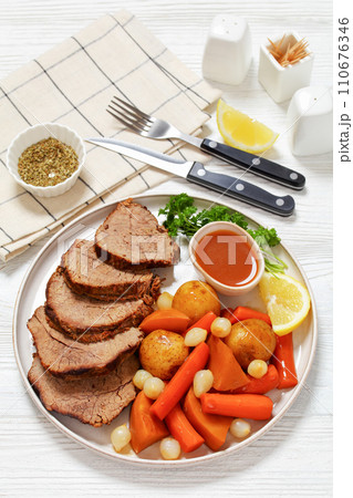 roast beef with dipping sauce and winter veggies 110676346