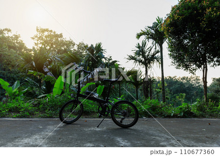 A folding bike on sunset road A folding bike on sunset road 110677360