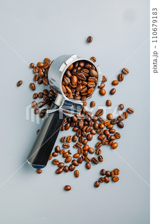 Coffee beans and portafilter on gray background. Top view. Coffee beans and portafilter on gray background. Top view. 110679183