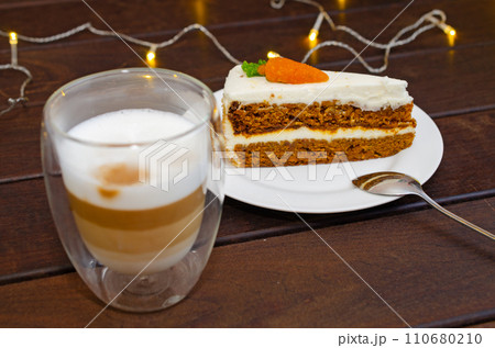 Carrot sponge cake with cream and walnuts and Cappuccino coffee Carrot sponge cake with cream and walnuts and Cappuccino coffee 110680210
