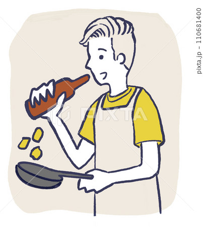 ビールを飲みながら料理をする男性 110681400