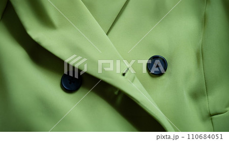 Green stylish suit with black buttons closeup 110684051