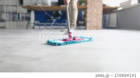 Person wiping floor with fluffy mop, domestic work, housewife cleaning at home Person wiping floor with fluffy mop, domestic work, housewife cleaning at home 110684141