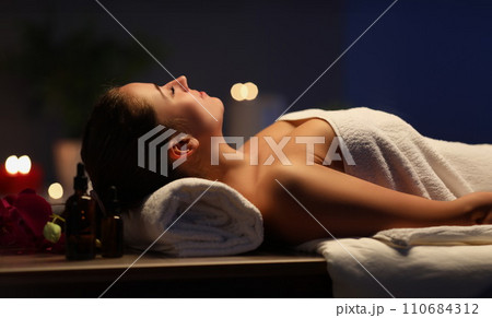 Relaxed girl lay with closed eyes on massage table in spa, wait for procedure to begin 110684312