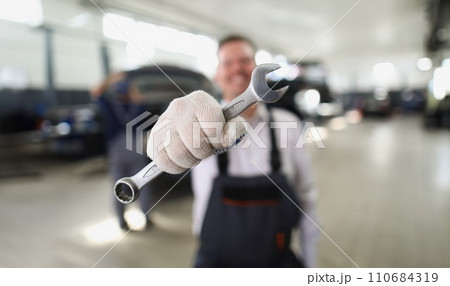 Service worker hold wrench equipment, metal tool to fix vehicle Service worker hold wrench equipment, metal tool to fix vehicle 110684319