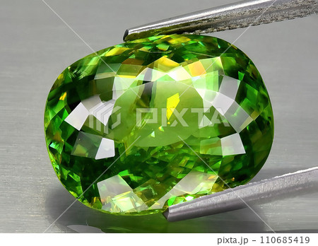 natural green sphene gem on the background 110685419