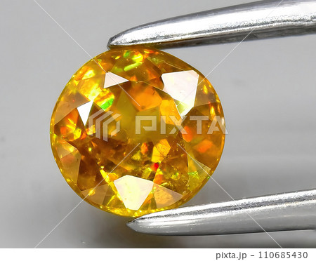 natural yellow sphene gem on the background 110685430