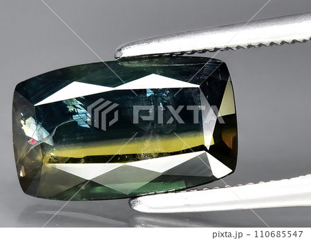 natural bi color sapphire gem on the background natural bi color sapphire gem on the background 110685547