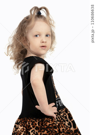 Five year old girl on a white background. Beautiful child. Little girl model. Curly-haired blonde. Preschool girl portrait. Five year old girl on a white background. Beautiful child. Little girl model. Curly-haired blonde. Preschool girl portrait. 110686638