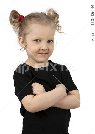 Little cheerful girl on a white background. Four-year-old child in a tight T-shirt. Little blonde with a smile. 110686644