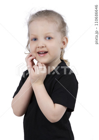 Little girl in a black t-shirt on a white background. Four year old child. 110686646